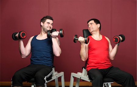 friends lifting someone - Men lifting weights together in gym Stock Photo - Premium Royalty-Free, Code: 649-03882004