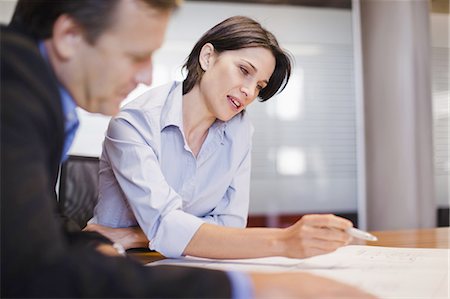 people sitting at a table - Business people working in office Stock Photo - Premium Royalty-Free, Code: 649-03882413