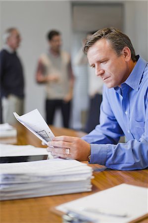 simsearch:614-06043814,k - Businessman reading in meeting Stock Photo - Premium Royalty-Free, Code: 649-03882433