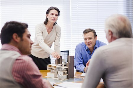 Business people examining model Stock Photo - Premium Royalty-Free, Code: 649-03882444