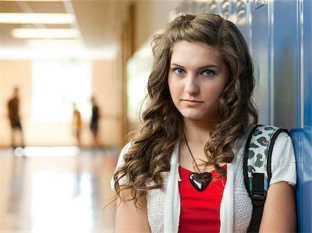 female student locker - USA, Utah, Portrait of teenage girl (14-15) in school corridor Stock Photo - Premium Royalty-Free, Code: 640-05761047