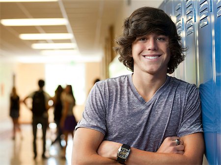 student (male) - USA, Utah, Portrait of young man in school corridor Stock Photo - Premium Royalty-Free, Code: 640-05761049
