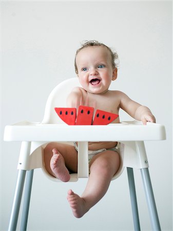 Baby boy (6-11 months) sitting on high chair Stock Photo - Premium Royalty-Free, Code: 640-05761241