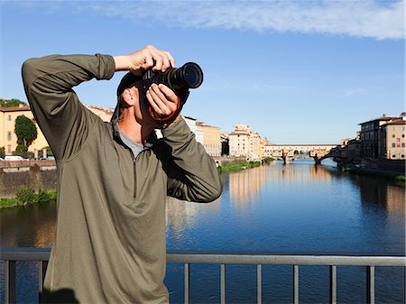 Italy, Florence, Man using camera on bridge over River Arno Stock Photo - Premium Royalty-Free, Code: 640-06049828