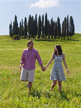simsearch:640-06049939,k - Italy, Tuscany, Val D'Orcia, Young couple walking on meadow Stock Photo - Premium Royalty-Free, Code: 640-06049947