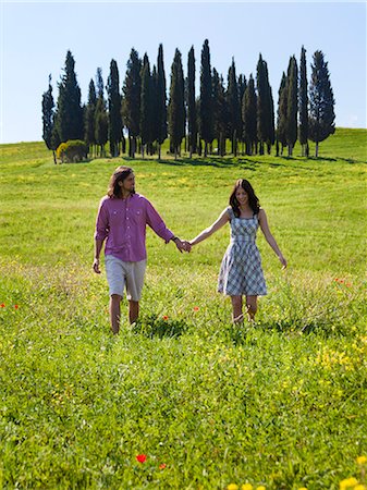 simsearch:640-06049939,k - Italy, Tuscany, Val D'Orcia, Young couple walking on meadow Stock Photo - Premium Royalty-Free, Code: 640-06049949