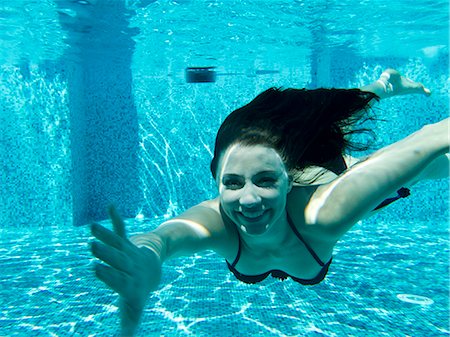 Italy, Ravello, Underwater portrait of swimming woman Stock Photo - Premium Royalty-Free, Code: 640-06049959