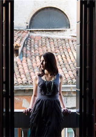 elegant woman looking away - Italy, Venice, Portrait of young woman with roofs in background Stock Photo - Premium Royalty-Free, Code: 640-06049990