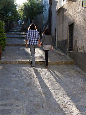 simsearch:640-06050299,k - Italy, Amalfi Coast, Ravello, Young couple holding hands and walking, rear view Stock Photo - Premium Royalty-Free, Code: 640-06050004