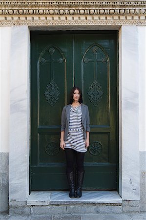 Italy, Ravello, Portrait of young woman standing in front of door Stock Photo - Premium Royalty-Free, Code: 640-06050005