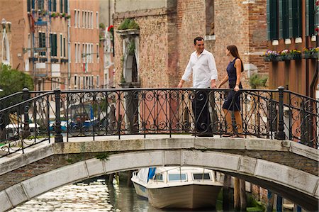 rail travel - Italy, Venice, Mature couple holding hands and walking through bridge Stock Photo - Premium Royalty-Free, Code: 640-06050149