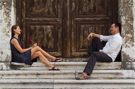 simsearch:640-06049939,k - Italy, Venice, Mature couple sitting at steps, woman holding single red rose Stock Photo - Premium Royalty-Free, Code: 640-06050164