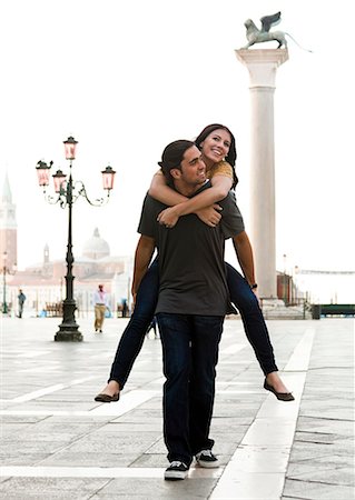 simsearch:640-06050299,k - Italy, Venice, Young man giving piggyback ride to woman on St. Mark's Square Stock Photo - Premium Royalty-Free, Code: 640-06050268