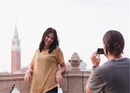 simsearch:640-06050299,k - Italy, Venice, Young man photographing woman on bridge San Giorgio Maggiore church in background Stock Photo - Premium Royalty-Free, Code: 640-06050274