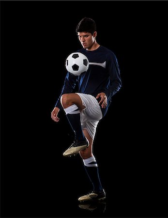 Soccer player juggling the ball. Stock Photo - Premium Royalty-Free, Code: 640-06050672