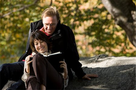 USA, New York City, Manhattan, Central Park, Mature couple reading book in Central Park Stock Photo - Premium Royalty-Free, Code: 640-06050692