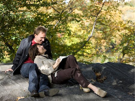 USA, New York City, Manhattan, Central Park, Mature couple reading book in Central Park Stock Photo - Premium Royalty-Free, Code: 640-06050693