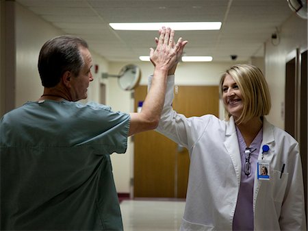 photos of us doctors - USA, Utah, Payson, Mature doctors making high five Stock Photo - Premium Royalty-Free, Code: 640-06050778