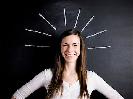 young woman against a chalkboard Stock Photo - Premium Royalty-Free, Code: 640-06051056