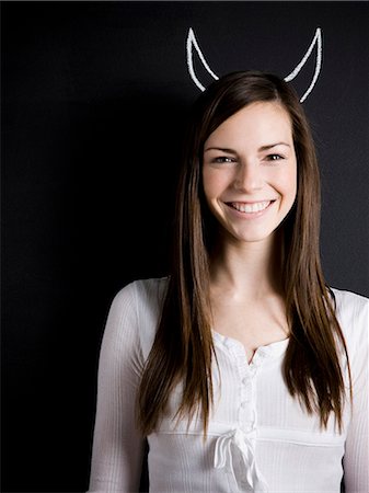 devil - young woman against a chalkboard Stock Photo - Premium Royalty-Free, Code: 640-06051050
