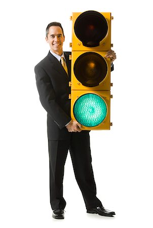 businessperson holding a traffic signal Stock Photo - Premium Royalty-Free, Code: 640-06051228