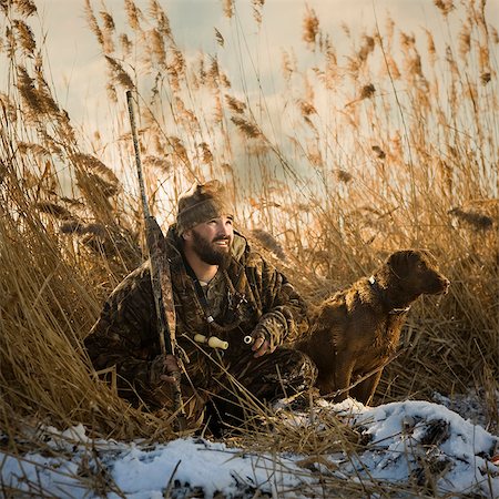 reed (grass) - man and his dog duck hunting Stock Photo - Premium Royalty-Free, Code: 640-06051653