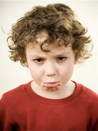 sulky tantrum - boy making a frowny face Stock Photo - Premium Royalty-Free, Code: 640-06052230
