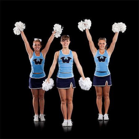 Studio shot of cheerleaders (16-17) dancing Stock Photo - Premium Royalty-Free, Code: 640-06963647