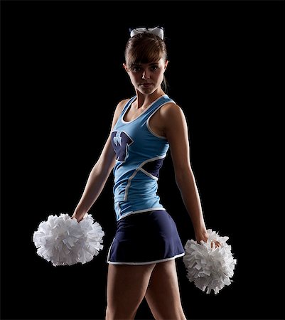 Studio shot of cheerleader (16-17) striking pose Stock Photo - Premium Royalty-Free, Code: 640-06963661