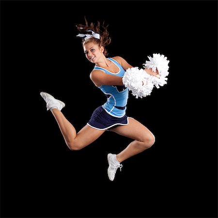 Studio shot of cheerleader (16-17) jumping Stock Photo - Premium Royalty-Free, Code: 640-06963663