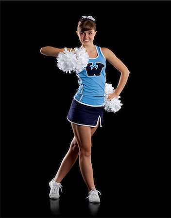 Studio shot of cheerleader (16-17) striking pose Stock Photo - Premium Royalty-Free, Code: 640-06963670