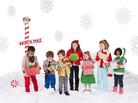 Group of kids (18-23months, 2-3, 4-5, 6-7) standing next to North Pole sign Stock Photo - Premium Royalty-Free, Code: 640-06963746