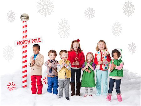 Group of kids (18-23months, 2-3, 4-5, 6-7) standing next to North Pole sign Stock Photo - Premium Royalty-Free, Code: 640-06963749