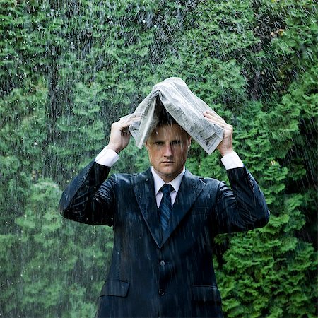 drenched - man in a suit standing next to a sprinkler Stock Photo - Premium Royalty-Free, Code: 640-08089139