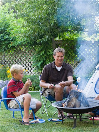 family tent backyard - father and son roasting marshmallows Stock Photo - Premium Royalty-Free, Code: 640-08089174