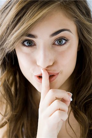 shhh - woman with her finger to her lips Stock Photo - Premium Royalty-Free, Code: 640-08089686