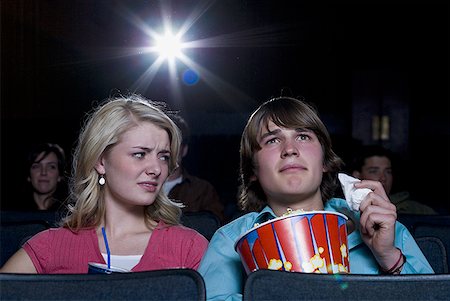 simsearch:640-02773406,k - Boy with tissues crying at movie theater with girl watching Stock Photo - Premium Royalty-Free, Code: 640-01348307