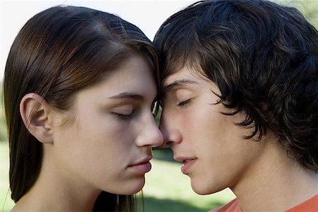 Close-up of a teenage couple kissing Stock Photo - Premium Royalty-Free, Code: 640-01348456