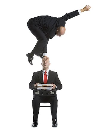 Two male acrobats in business suits performing Stock Photo - Premium Royalty-Free, Code: 640-01348452