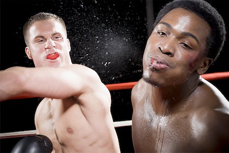 face front man - Close-up of two young men fighting in a boxing ring Foto de stock - Sin royalties Premium, Código: 640-01348471