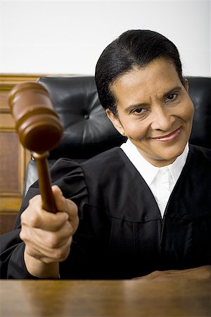 simsearch:640-01350504,k - Portrait of a female judge holding a gavel and smiling Foto de stock - Sin royalties Premium, Código: 640-01348563