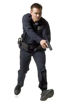 Male police officer pointing gun Stock Photo - Premium Royalty-Free, Code: 640-01348622