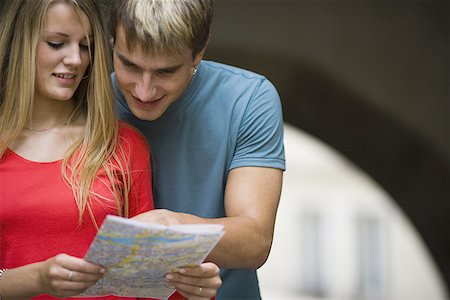 Close-up of a teenage couple looking at a map Stock Photo - Premium Royalty-Free, Code: 640-01348728