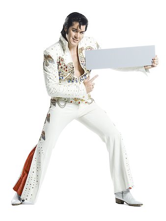 Portrait of an Elvis impersonator holding a blank sign Stock Photo - Premium Royalty-Free, Code: 640-01348723