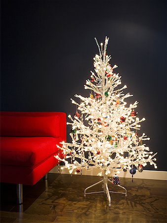 Close-up of a Christmas tree beside a couch Stock Photo - Premium Royalty-Free, Code: 640-01348776