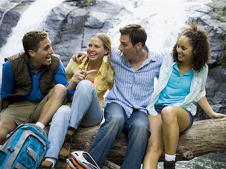 Close-up of two young women and two young men talking to each other Stock Photo - Premium Royalty-Free, Code: 640-01349102