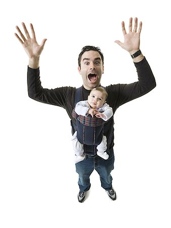 Portrait of a young man carrying his daughter in a harness Stock Photo - Premium Royalty-Free, Code: 640-01349187