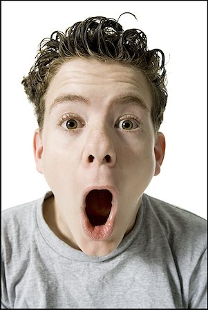Portrait of a teenage boy with his mouth open Foto de stock - Sin royalties Premium, Código: 640-01349251