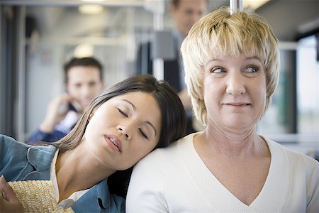 Close-up of a young woman sleeping on a mature woman's shoulder Stock Photo - Premium Royalty-Free, Code: 640-01349344