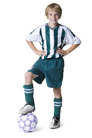 Portrait of a boy with his foot on a soccer ball Stock Photo - Premium Royalty-Free, Code: 640-01349474